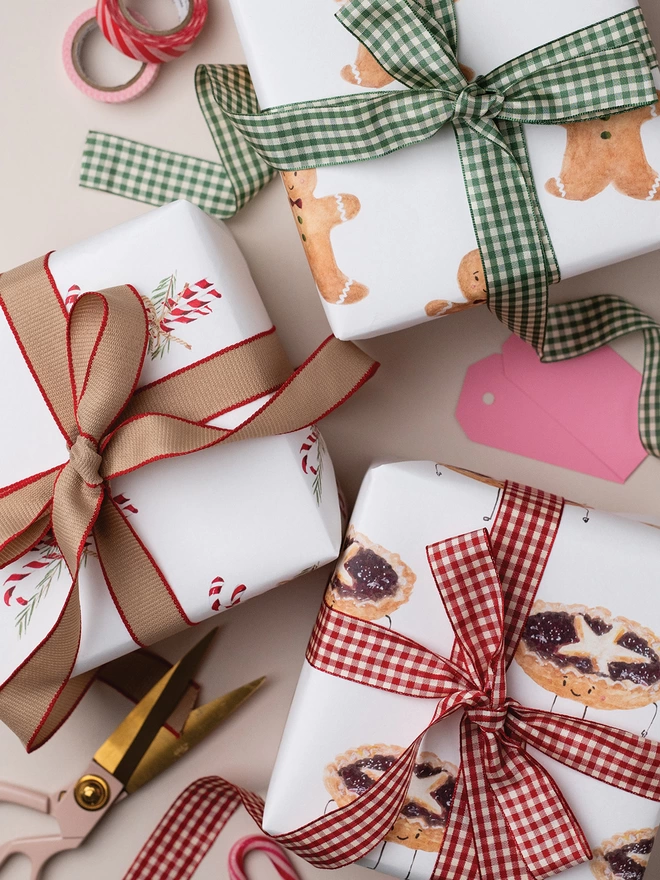 Three beautifully wrapped gifts using Mince Pie Gift Wrap, Candy Cane Gift Wrap and Gingerbread Men Gift Wrap.  Hand tied with a beautiful contrast ribbon 