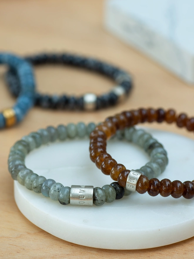 Create a piece that tells their story with the Nomad Bracelet. Featuring jade and labradorite beads in Tide Blue, Stone Grey, Slate Grey or Earth Brown, this stretch bracelet is finished with hand-stamped sterling silver life beads. A personalised beaded bracelet that blends rugged natural beauty with modern style — a thoughtful gift for him (and secretly great for her too).