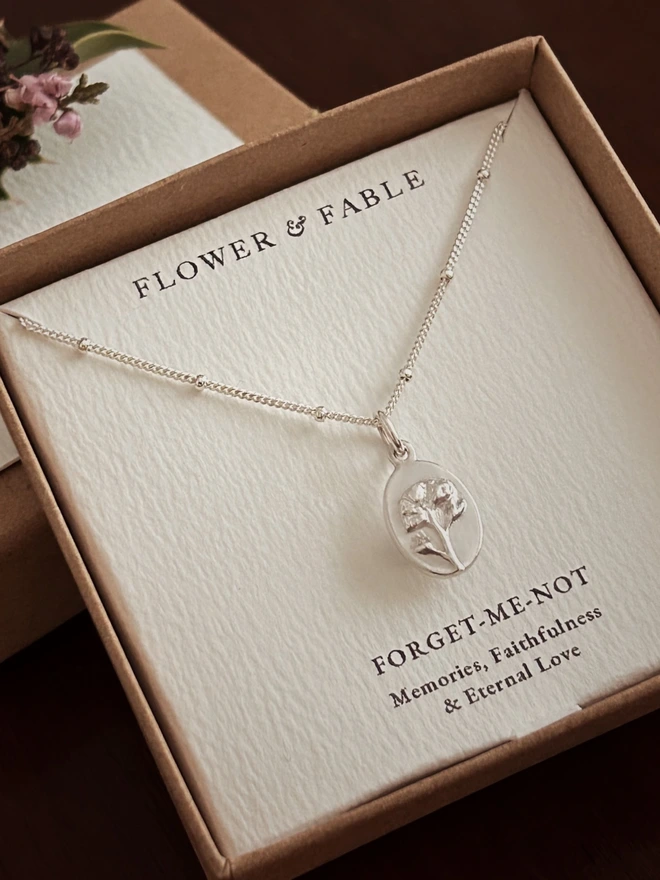 Forget me not medal on a curb satellite chain in our gift box