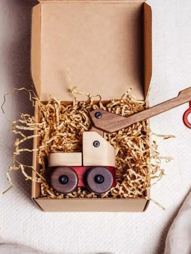 Walnut & Padauk Crane Wood Heirloom Toy, on a white table, packaging, 