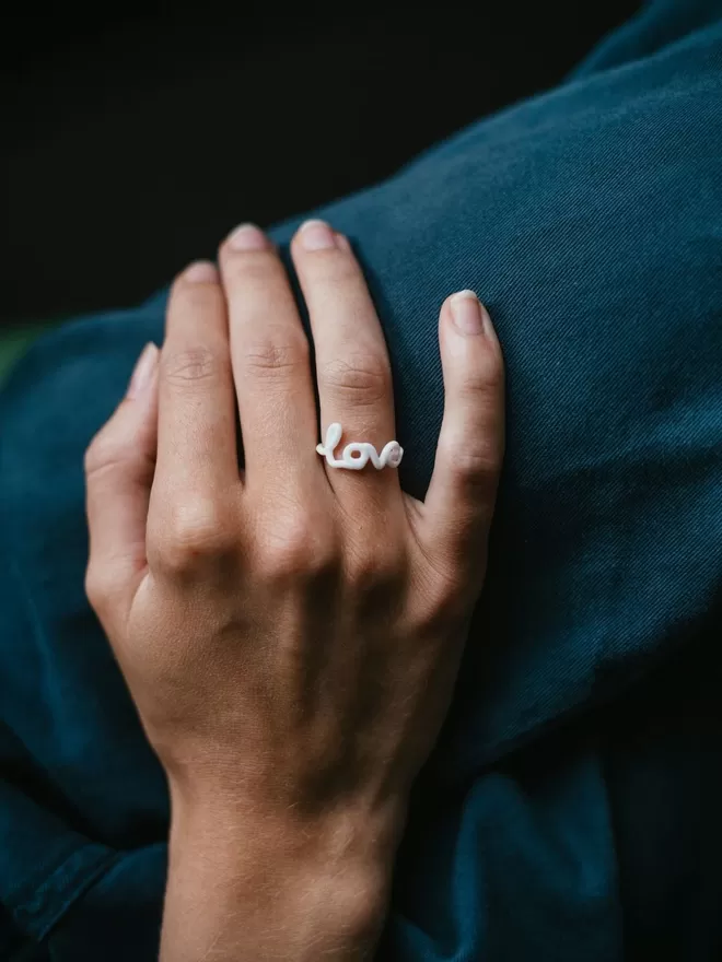 Zoe Sherwood love ring in white.