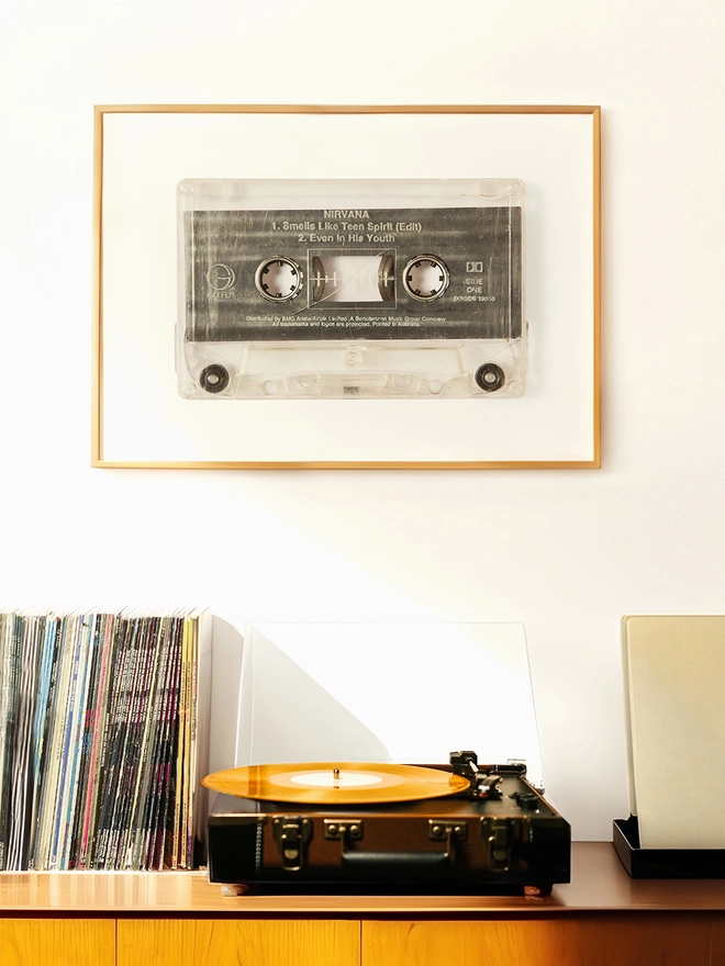 Nirvana 'Smells Like Teen Spirit cassette tape print. framed print hung up above record player and vinyl collection.