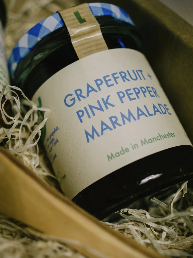 Jar Of Grapefruit & Pink Peppercorn Marmalade, jar of marmalade in a box packaged. 