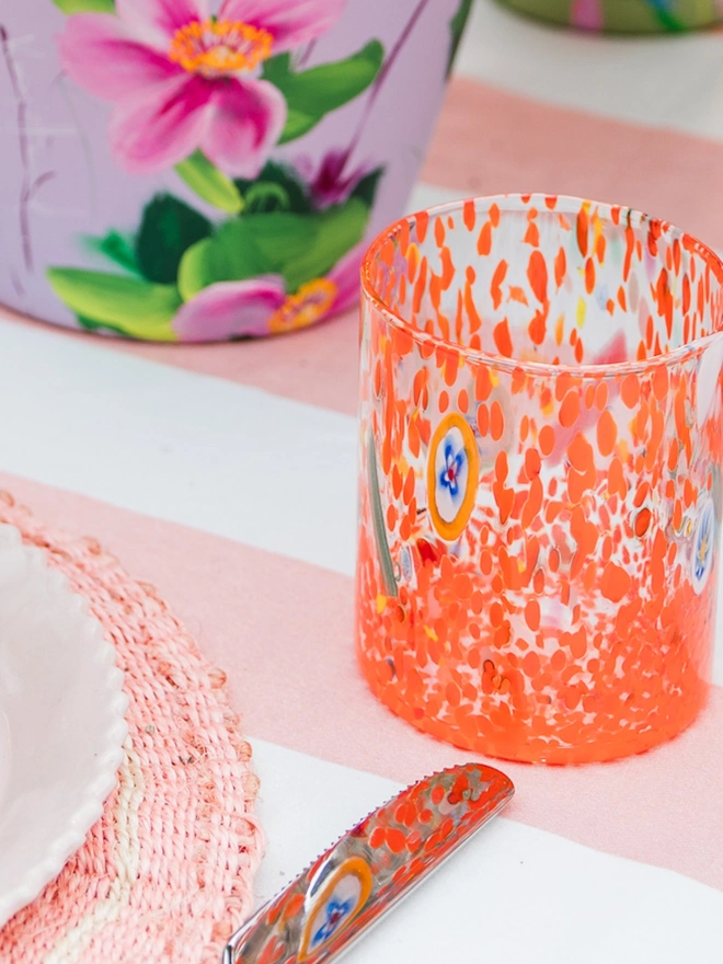orange speckle glass on springy decorated table