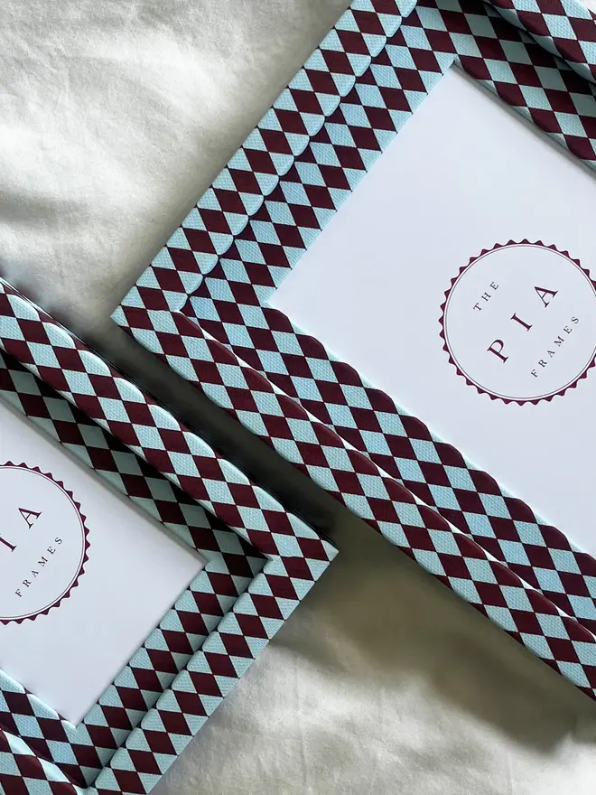 Burgundy & Blue Harlequin Frame, a patterned colourful frame sitting on a plain white surface. 
