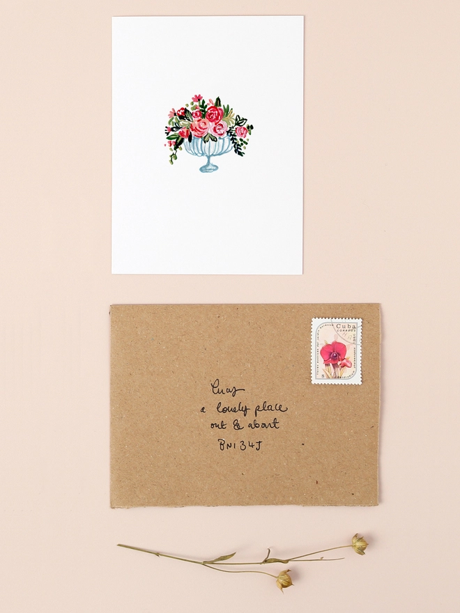 A delicate illustration of a vintage-style glass vase filled with a lush bouquet of soft pink, red, and cream roses. The roses are depicted with intricate detailing, showcasing their gentle petals and natural beauty. The vase sits gracefully against a neutral background, exuding an elegant and timeless charm. This mini card is perfect for expressing appreciation, sending birthday wishes, or conveying heart