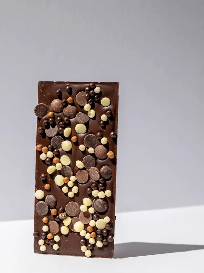 Loaded chocolate tablette standing on a white table. 