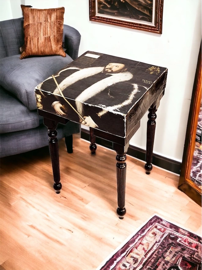 tall fluted leg side table with artwork on top