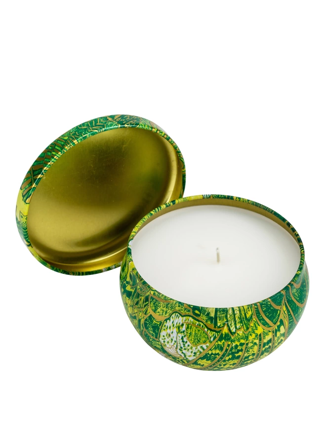 abundance of love gift of light travel charity candle lit tin opeded to view the candle and wick