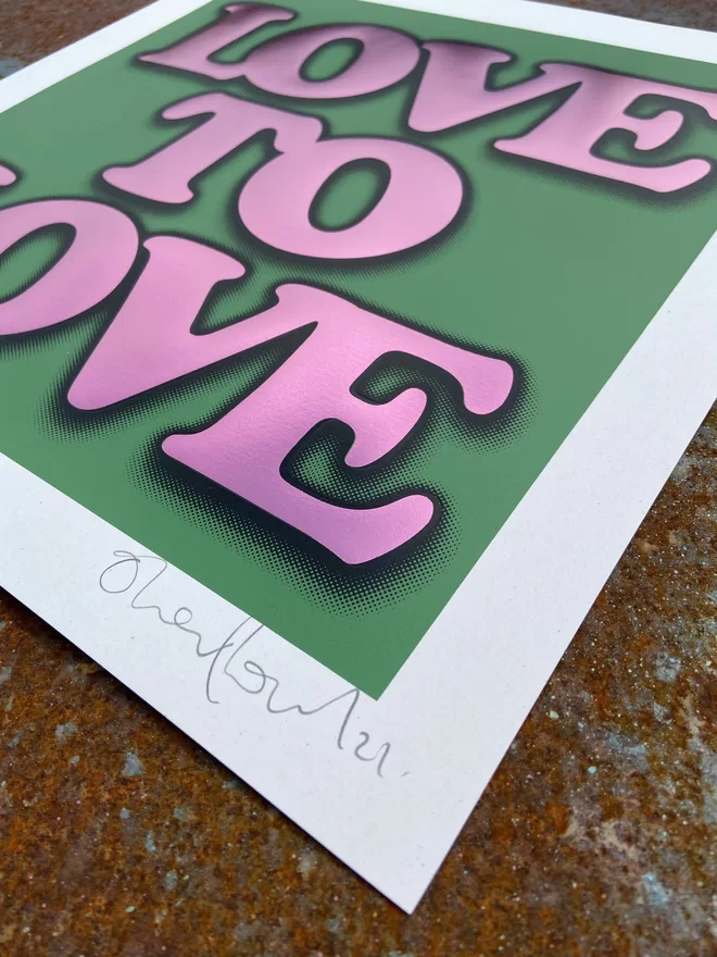 Metallic Hot Foil  "Love to Love" Screen Print in green. typography says love to love with a drop shadow the print is square 