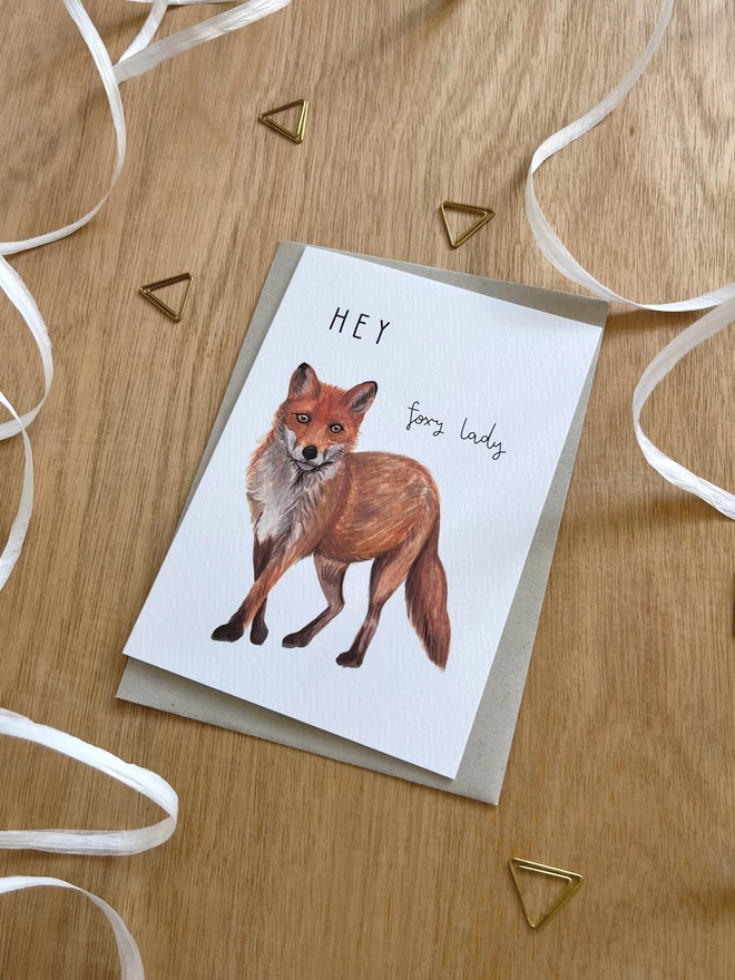 a greetings card featuring a fox illustration and the text “hey foxy lady”