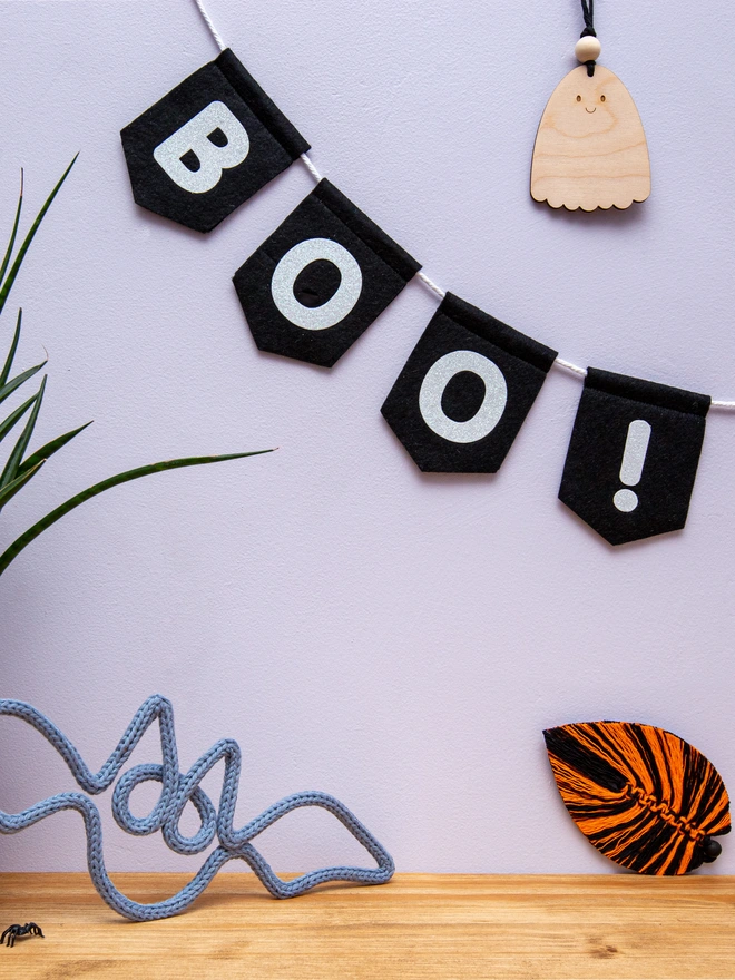 black, felt spearhead bunting with text that reads "BOO!" in white glitter felt