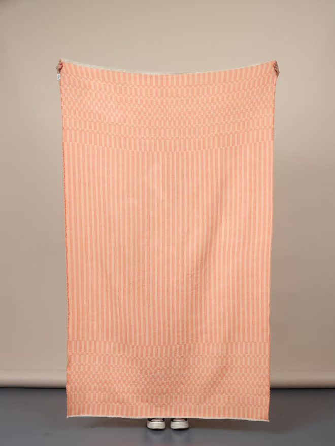 arabella lambswool blanket. a textured pink blanket photographed against a plain wall.