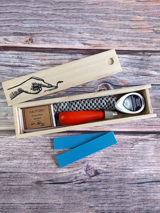 Carving kit in wooden box open to show contents