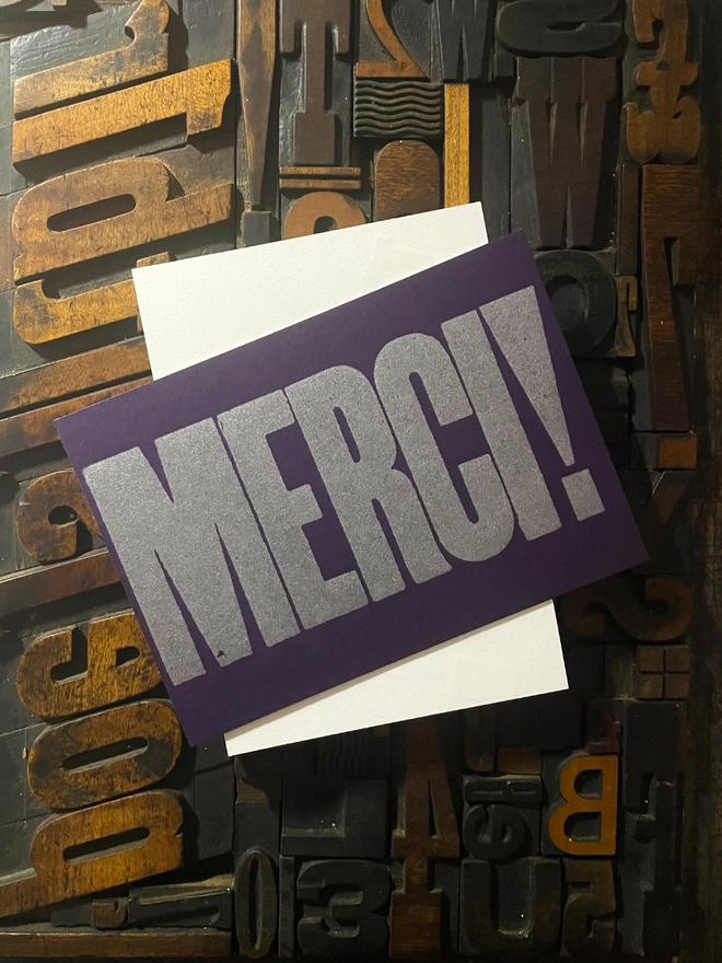 Merci! A beautiful typographic letterpress postcard printed with metallic silver inks printed on rich thick  colourful card with a luxury matching envelope; ideal to send a thank you note to a friend or loved one.