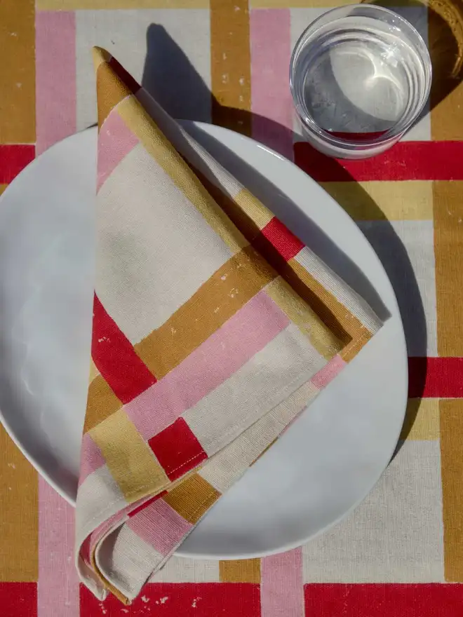 Folded napkin on plate on tablecloth