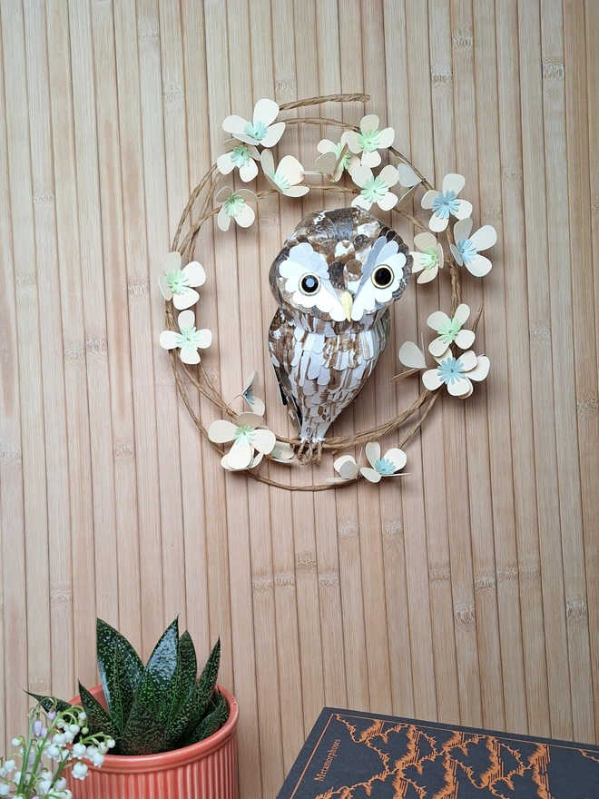 Handmade floral wreath featuring a boreal owl paper sculpture