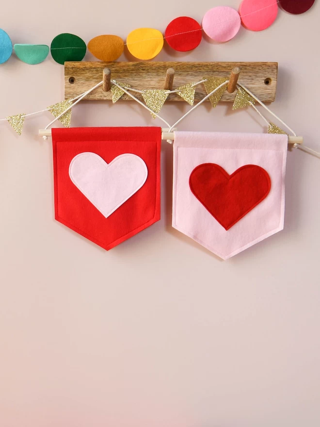 2 mini heart felt banners in pink and red.