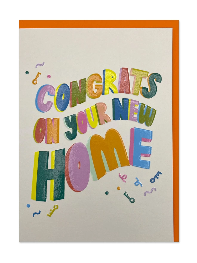 A colourful new home card with bold rainbow type and a heartfelt ‘Congrats on your new home’ message on a cream background