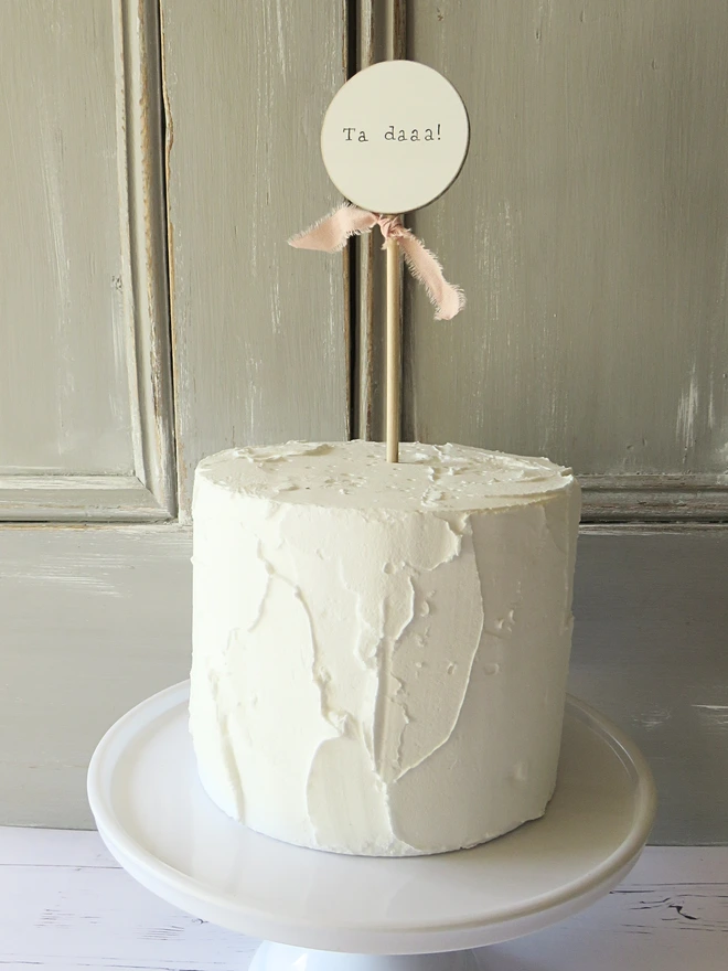 wooden circle shaped cake topper with hand painted message and custom ribbon