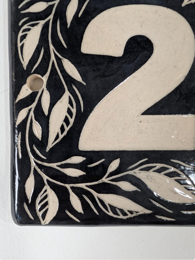 Personalised Ceramic House Number Leaf Tile. A tile in black.