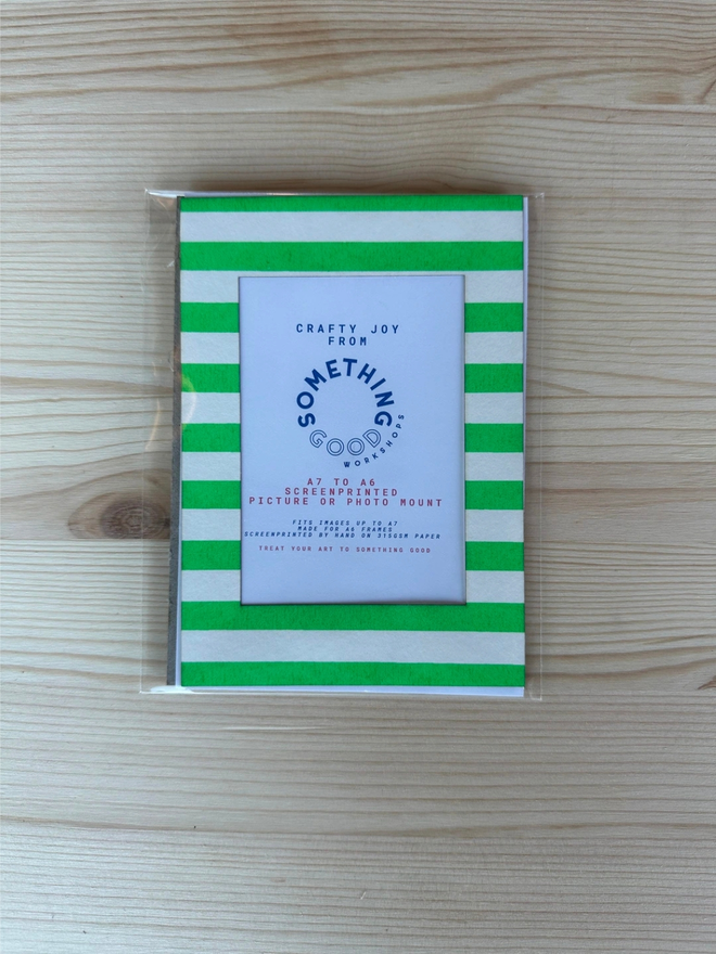 Thin Striped Screen Printed A6 / A5 / A4 Photo Mount. green striped mount pictured on a wooden table.