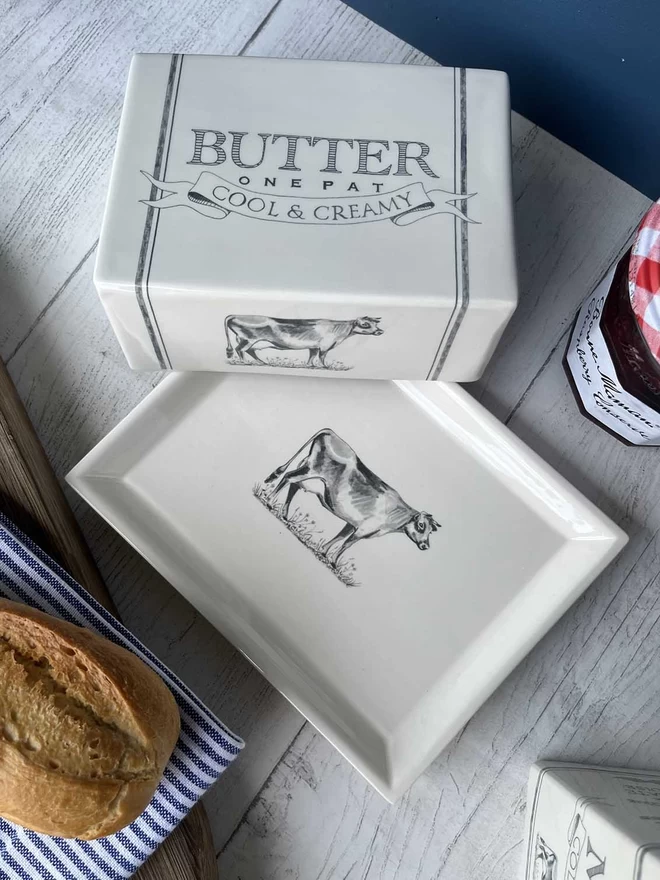 A handmade ceramic butter dish decorated is with Beatrice von Preussen Illustrations.