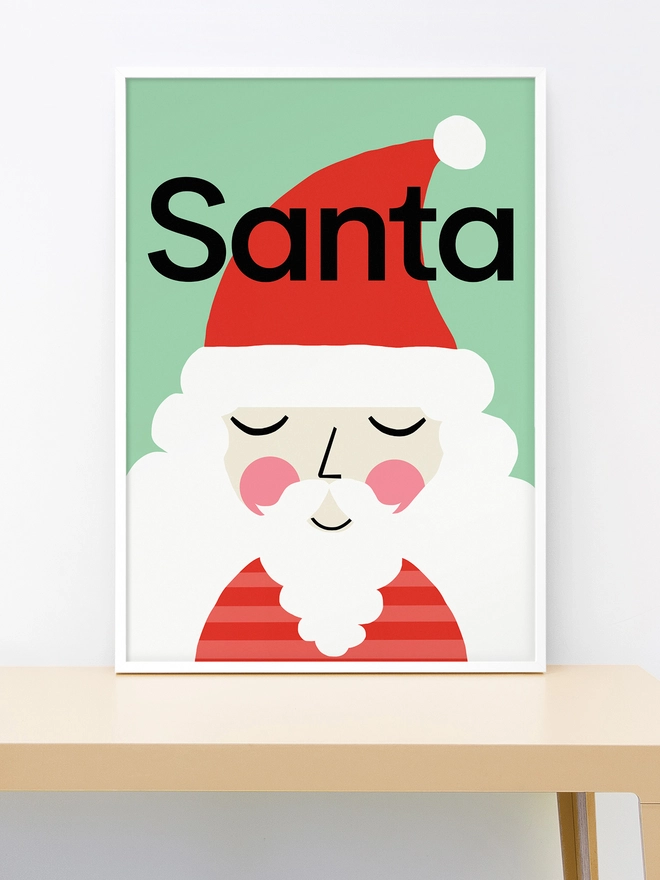 Framed wall print of an illustrated Santa Claus on a mint green background