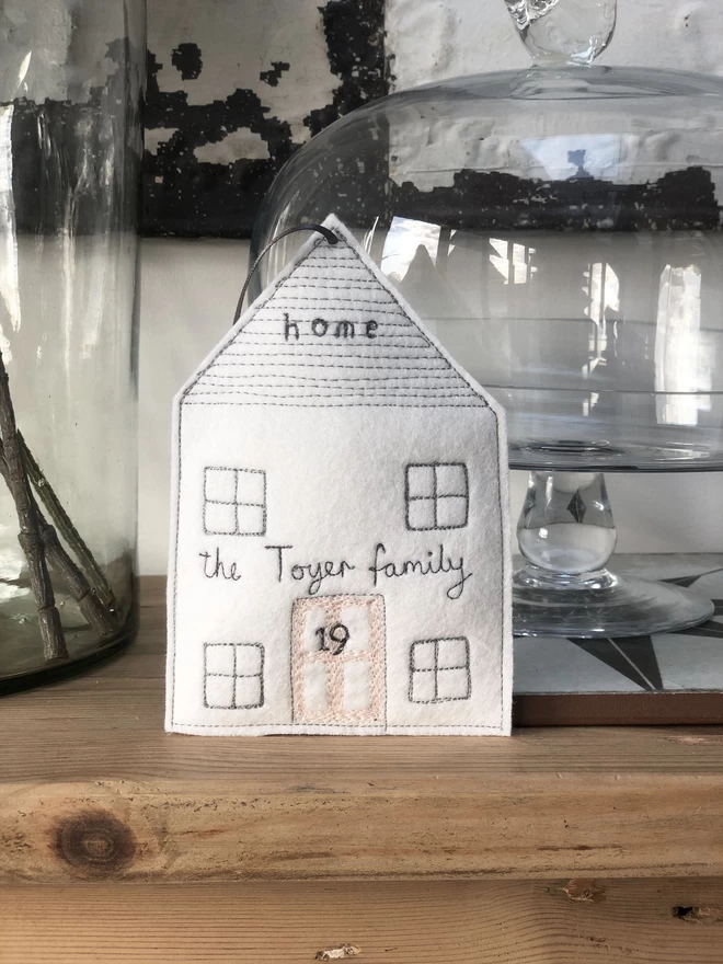 Home Personalised Embroidered Felt Decoration on shelf with cake dome