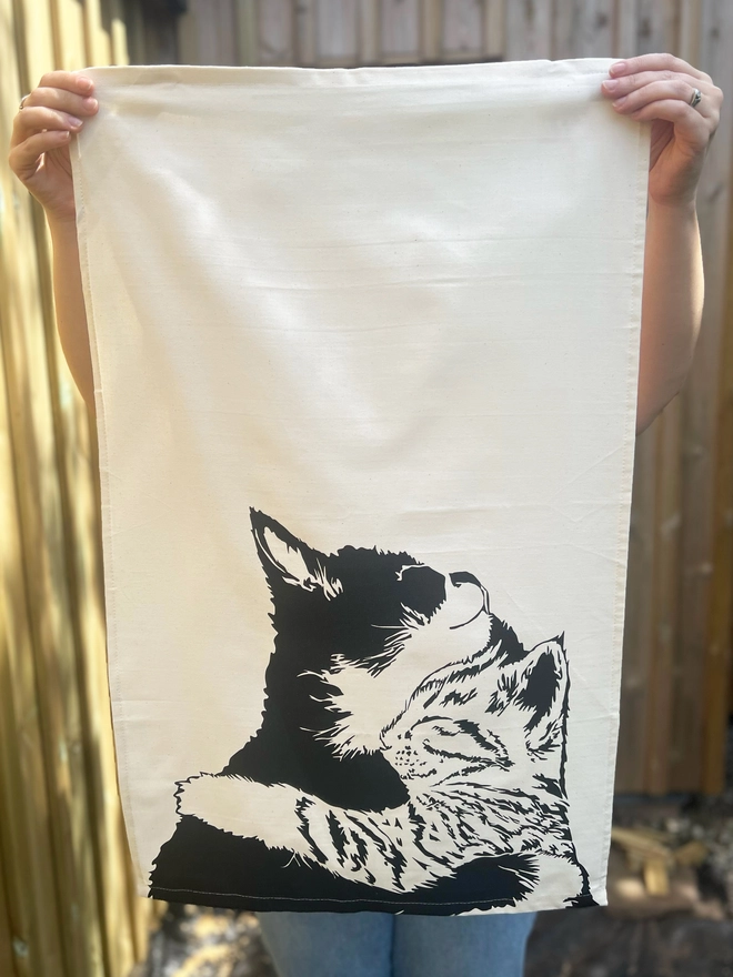 Full image of 'Cuddle time' tea towel with hand sewn edges and diagonal hanging loop