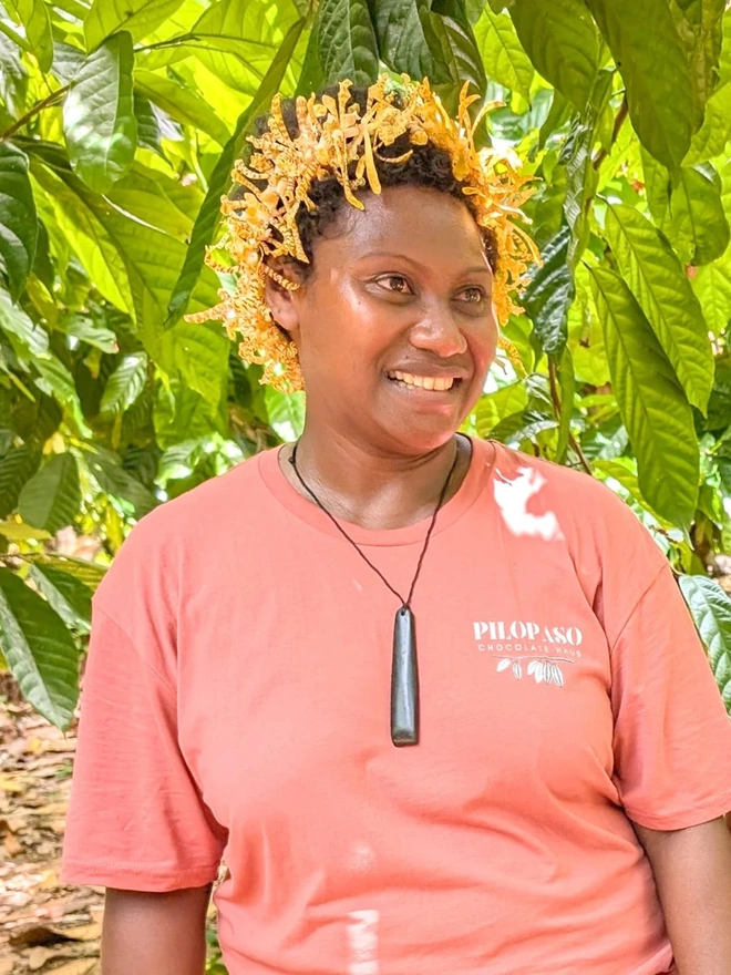 agnes standing and smiling under a tree