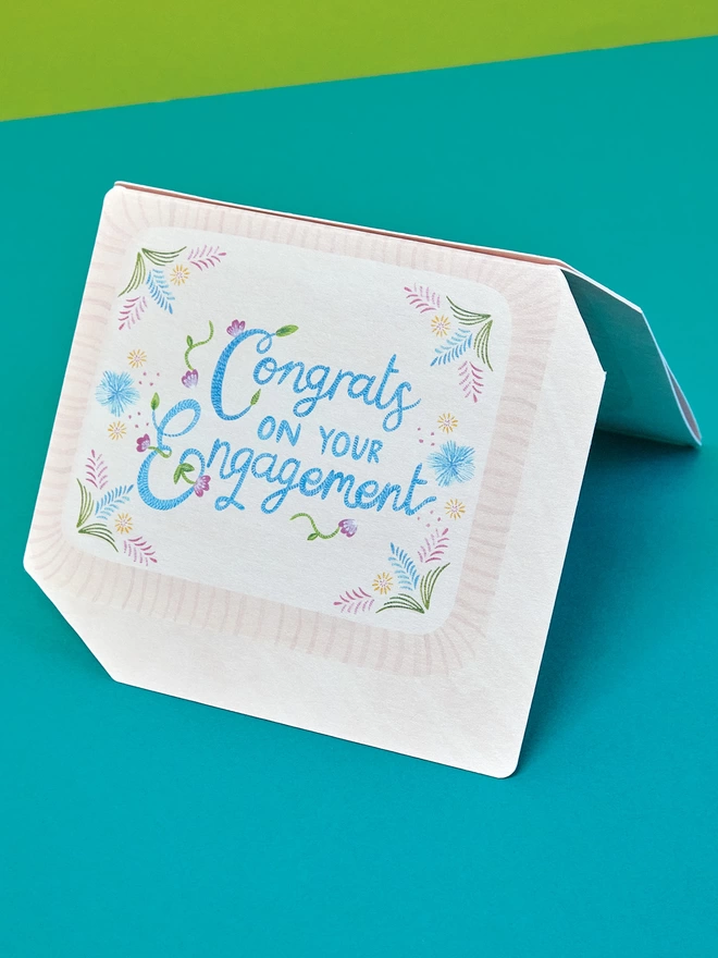 The front of the card has a 'Congrats on your engagement' message in beautifully painted hand lettering with stitch detailing, complete with embroidery look painted flowers 