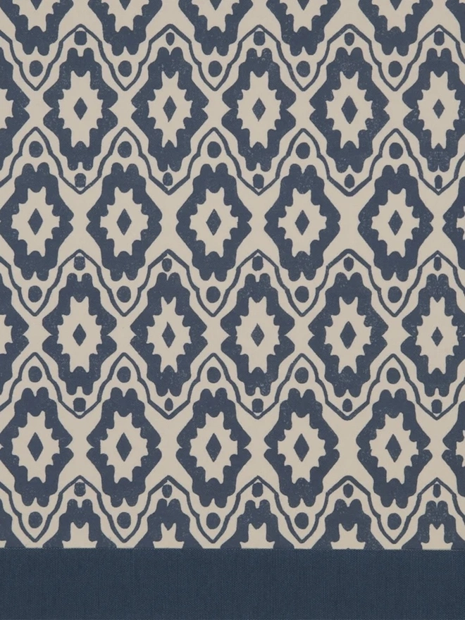 Retro Drum Lampshade. Close-up of a hand block printed lampshade showing a bold repeating geometric pattern. The colourful printed design and neat trim bring character and a handcrafted finish to any lamp.