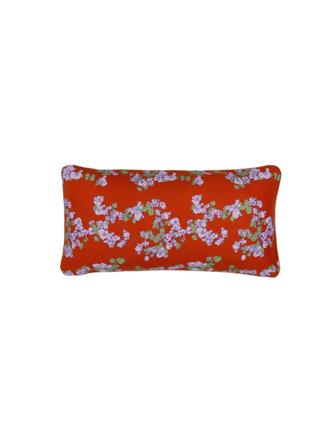 red floral cushion on blank background
