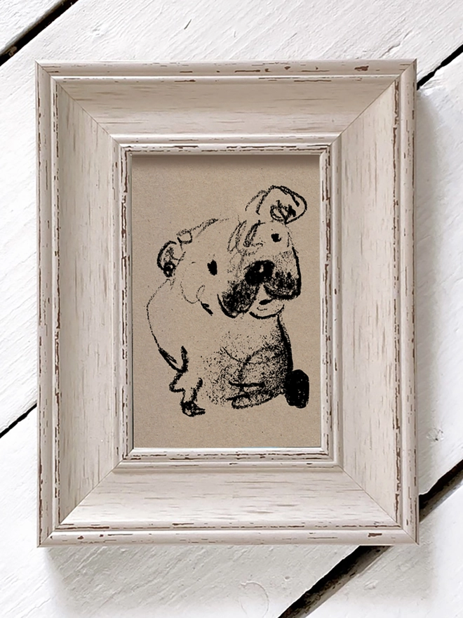 framed drawing of dog on brown paper