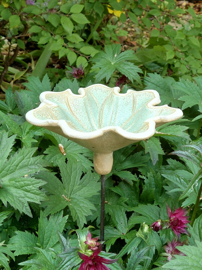 Seven petal ceramic flower bird bath on brass rod