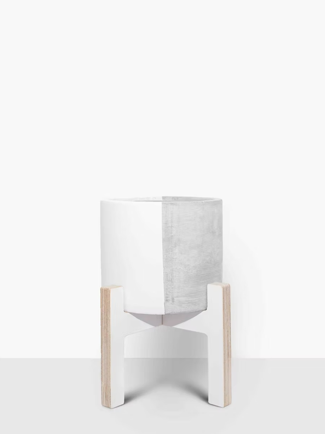 half & half concrete plant pot. a grey concrete plant pot painted half white.