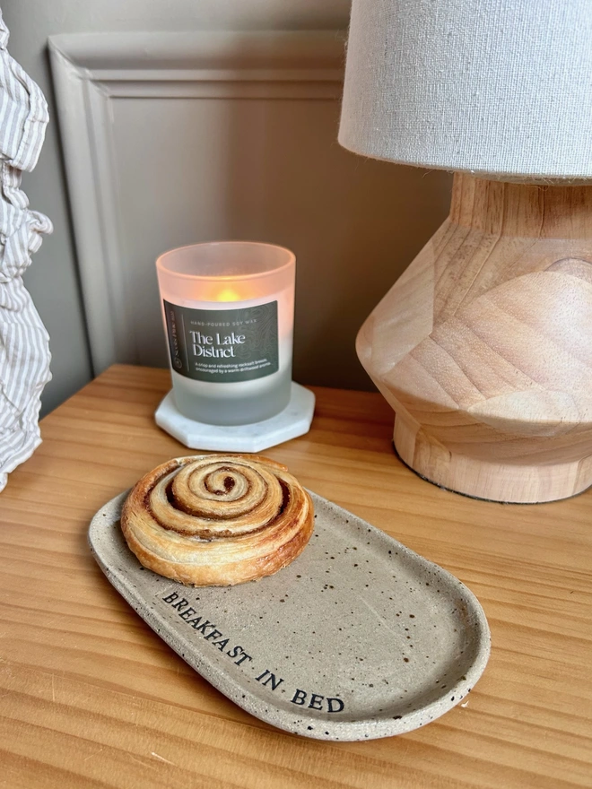 ceramic plate beside a candle and lamp