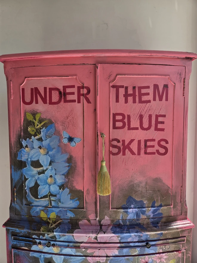 Painted vintage wooden cabinet with pink, blue and floral decoration