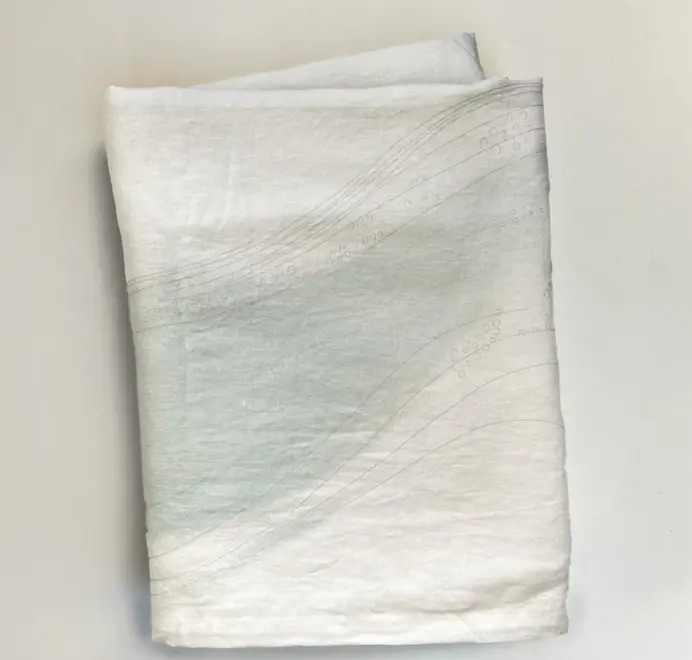 Imola Tablecloth. Light blue and white tablecloth with subtle abstract patterns. 