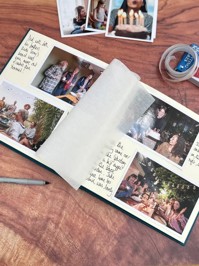 A Large Wedding Photo Album Personalised With Bespoke Printing, opened on a wooden surface to show messages and photos inside. 
