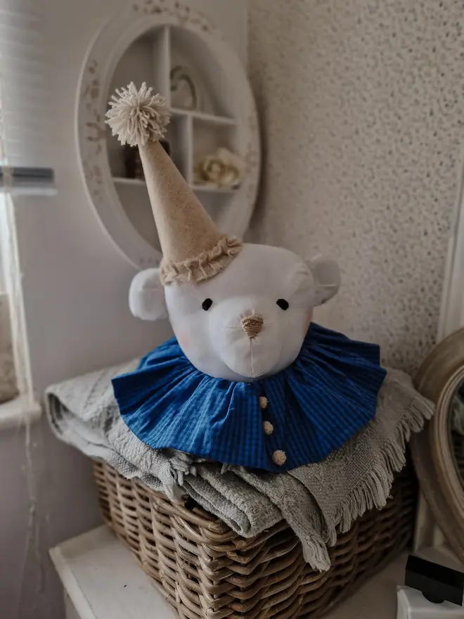 Bear Head Nursery Decoration, a bear decoration sitting against a wall in a child's decorated bedroom. 