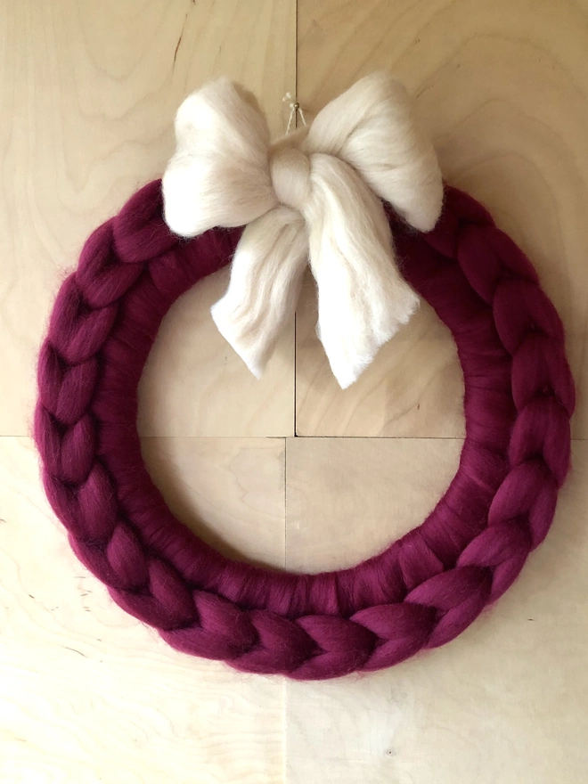 Chunky knitted wreath with bow.