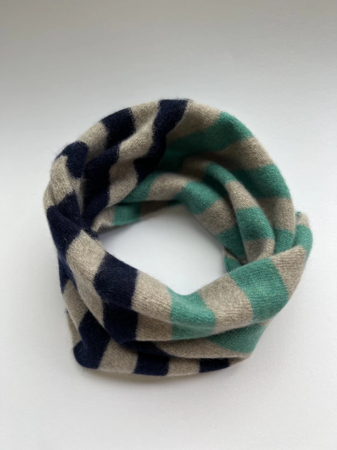 Jade mushroom navy knitted snood shown on a white background from overhead