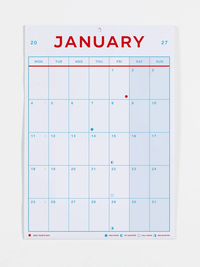 Monthly view calendar in red and blue on white recycled paper, photo shows the month of January