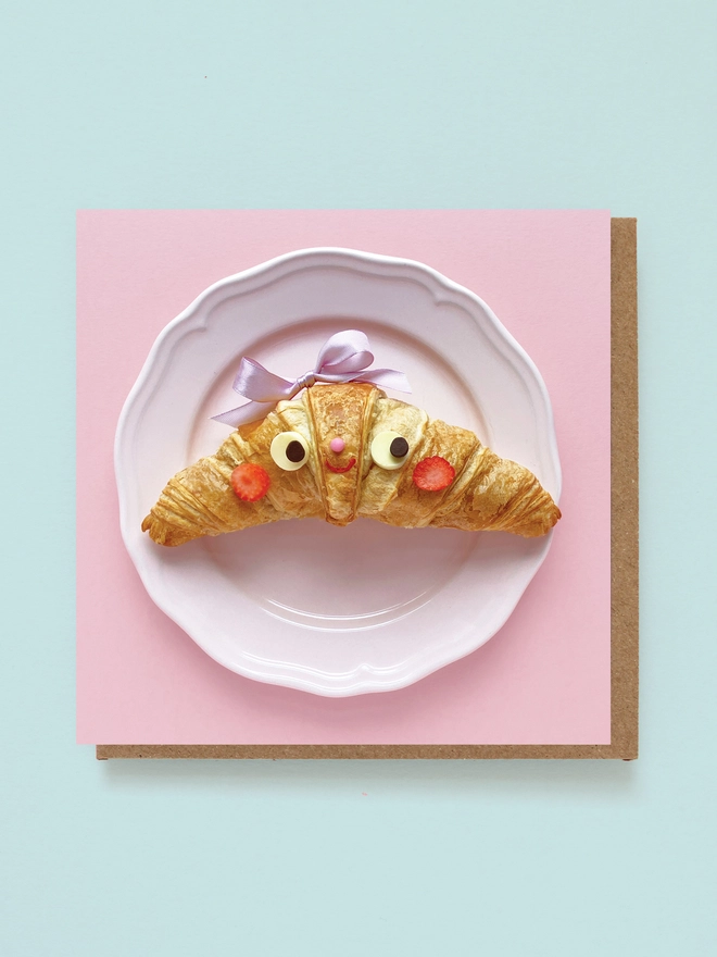 A cute crosiant with a bow 