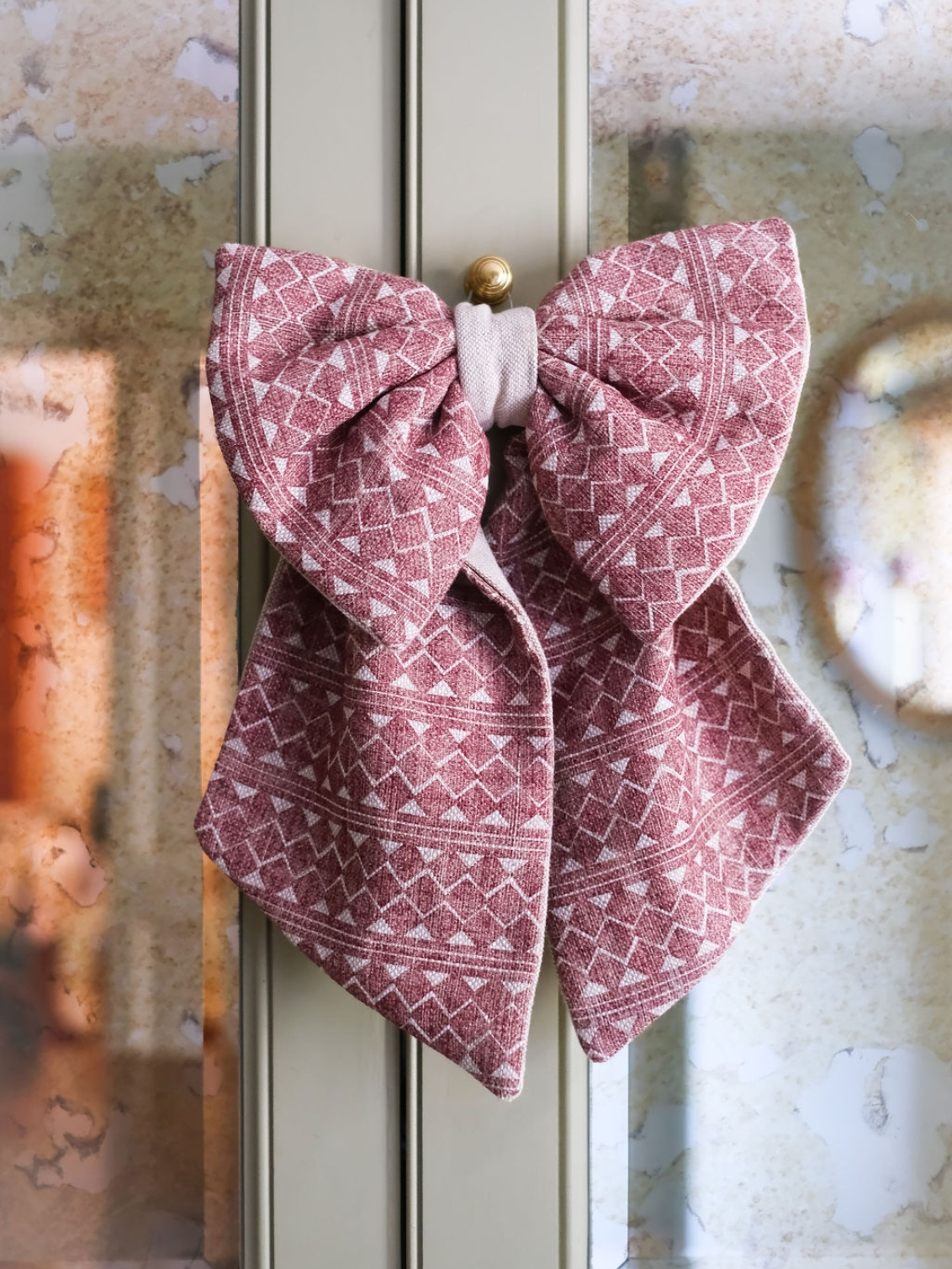 Large decorative bow made from remnant Fermoie Quantock Plum fabric 