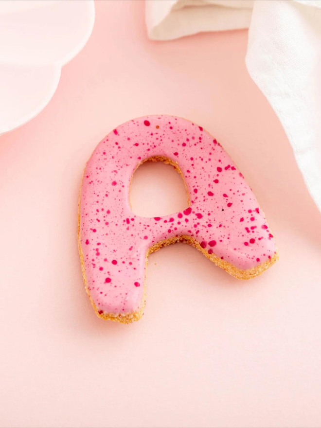 pink iced initial dog treat
