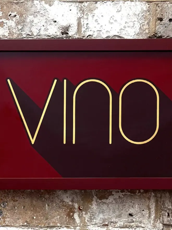 'Vino' Wine Serie Gold Leaf Glass Artwork, hanging in an exposed brick wall. 