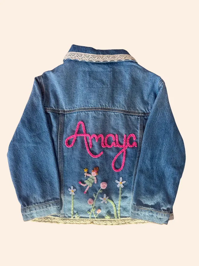 Hand-embroidered denim jacket with flowers and a fairy